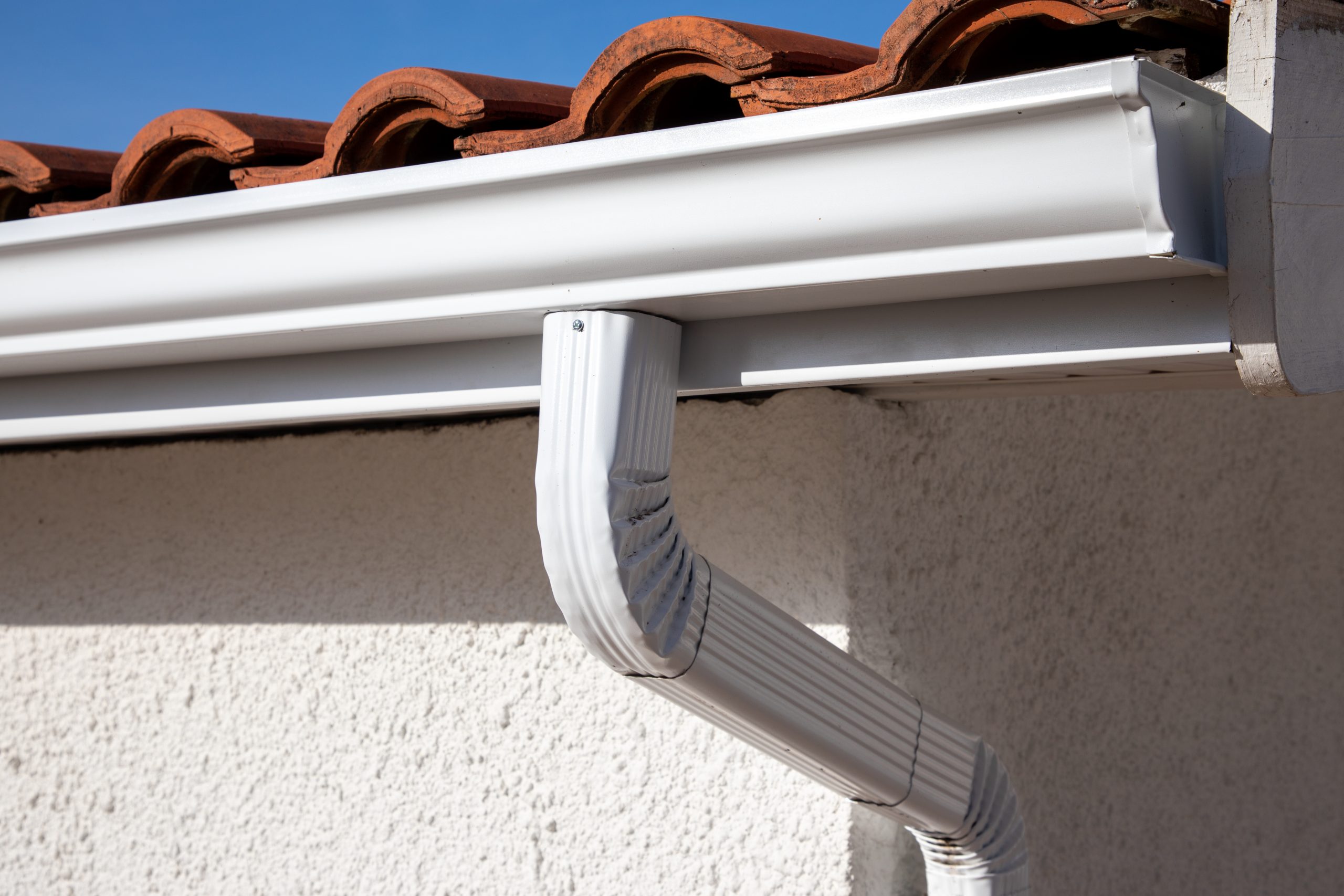 aluminum white gutter roof building downpipe wall scaled